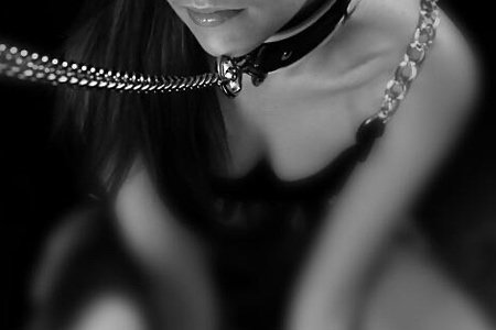 submissive woman wearing sub collar on lead