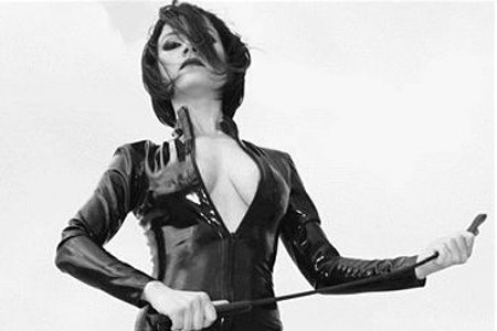 Dominant BDSM mistress holding whip